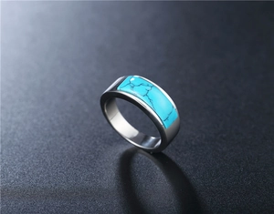 Macro view of men's titanium steel ring with a rectangular turquoise gemstone inlay
