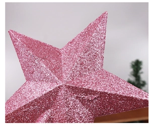 Close-up of a pink glittery five-pointed star topper for Christmas tree decoration