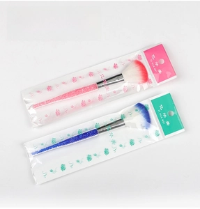 Detail of fan makeup brushes with crystal diamond handles in sealed packaging