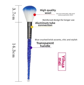 Detail of makeup brush with blue gradient bristles and crystal diamond filled handle