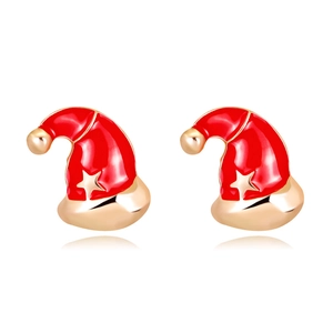 Close-up of red and gold Christmas hat earrings with star pattern on white background