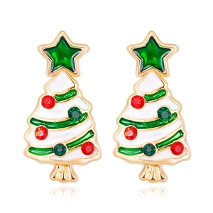Close-up of golden Christmas tree earrings with white enamel and sparkling rhinestones