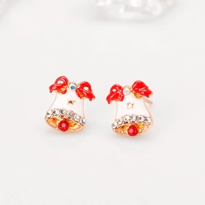Close-up of Christmas bell earrings with red bows and sparkling red zircon stones