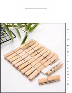 Detailed close-up of 20 natural bamboo clothespins with durable metal springs