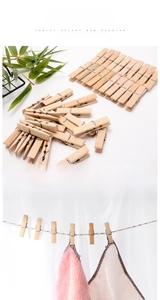 Bamboo clothespins shown hanging a white towel on a rope with a clean natural background