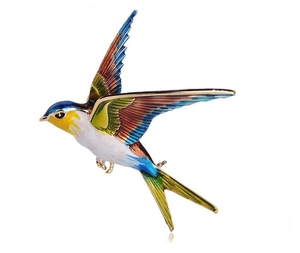 Detailed close-up of a flying swallow bird brooch with colorful enamel gradient finish