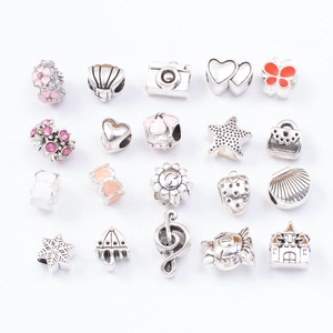 Detailed assortment of silver metal charms and colorful enamel pendants for DIY bracelets