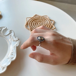 Close-up of vintage 925 silver oval ring with braided texture and antique finish