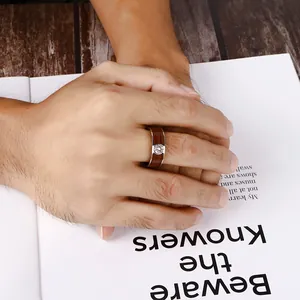 Men's stainless steel ring with brown wood inlay and round metal detail on finger
