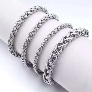 Multiple sizes of silver stainless steel curb chain bracelets for men on a white display