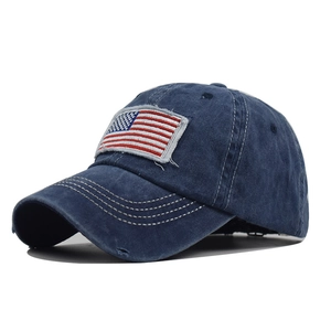 Detail of navy blue washed cotton baseball cap featuring embroidered American flag patch