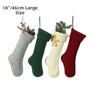 Detail of 18 inch large knitted Christmas stockings with diamond pattern and hanging loops