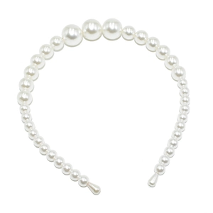 Detailed close-up of large white faux pearls on a wedding headband with smooth ends