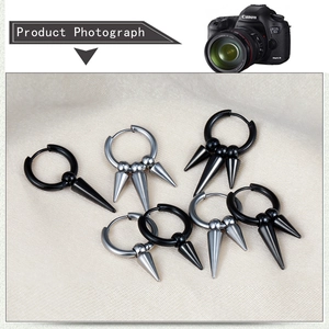 Detail view of punk style stainless steel hoop earrings with hanging metal spikes
