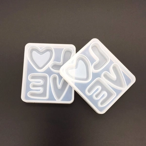 Detail of translucent silicone alphabet molds with LOVE letters and heart shapes for DIY resin