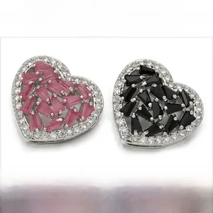 Detail of heart jewelry connectors with pink and black zircon in silver plating