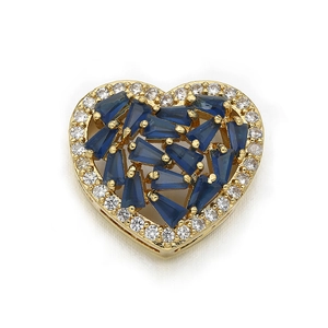 Macro shot of gold heart connector with blue gemstone and clear cubic zirconia pavé