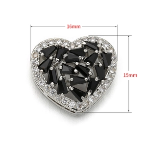 Detail shot of heart connector with black zircons and white crystals measuring 16x15mm