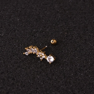 Macro shot of gold star-shaped stud earring with clear zircon inlay and screw back design