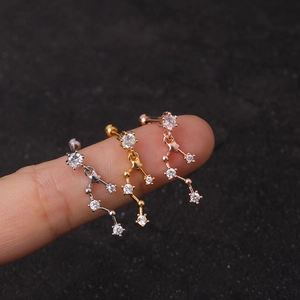 Constellation zircon cartilage studs in silver, gold, and rose gold on fingertips