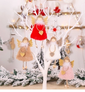 Detail of plush angel ornaments with golden sequin wings on a white branch