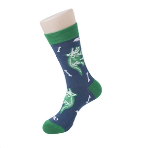 Detail of navy blue cotton sock with dinosaur fossil pattern and green trim