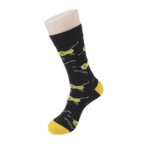 Close-up of black cotton crew socks with yellow heels and serotonin molecule pattern