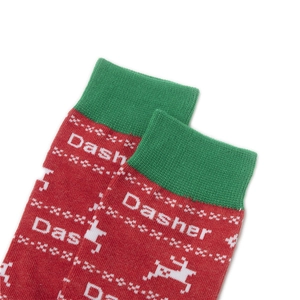 Close-up of festive red Christmas socks featuring a white reindeer pattern and Dasher text