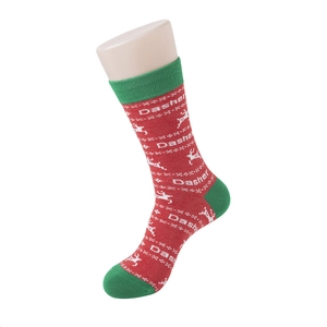 Detail of red Christmas socks with green heel and toe, featuring white Dasher reindeer motif