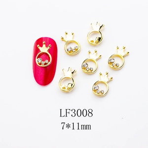 Detailed close-up of 7x11mm golden crown nail charms with rhinestones and pink display