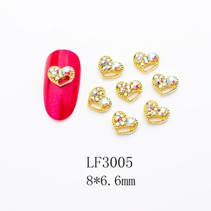 Macro view of 8*6.6mm heart nail art charms with gold frame and colorful rhinestones