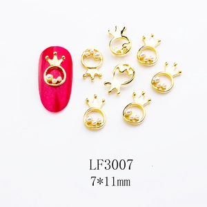 Detail view of 7x11mm golden crown nail art charms with three pearls and alloy finish
