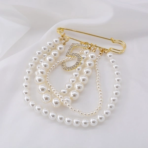 Elegant gold safety pin brooch with white pearl tassels and sparkling rhinestone number 5