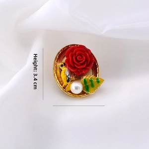 Detail of baroque brooch with red rose and bird design, size 3.4 cm height by 3 cm width