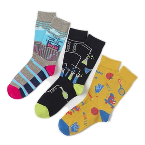 Detailed view of three pairs of printed crew socks with dog, science, and sport motifs