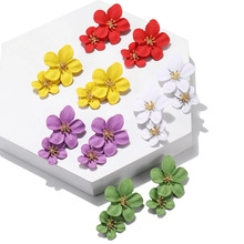 Detailed macro view of matte finish floral earrings in five vibrant assorted colors