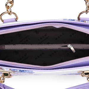 Floral print handbag with purple branded interior lining and golden chain hardware