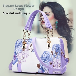Detail of elegant floral shell bag featuring purple handles and blue hibiscus prints
