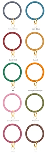 Grid display of silicone wristlet keychains in ten various matte colors with gold rings