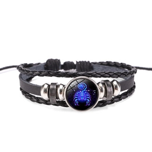 Detail of multi-layer braided leather bracelet with Scorpio zodiac sign charm