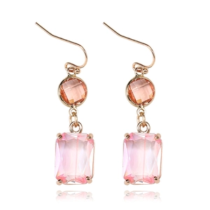 Macro detail of pink crystal drop earrings with rectangular K9 glass and gold hooks