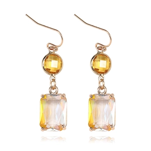 Detail of long geometric earrings with yellow K9 crystals and golden hooks on white background