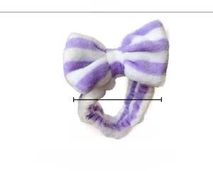 Detail view of purple striped plush headband showing the width measurement of about 15cm