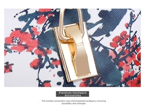 Close-up of golden hardware buckle and floral pattern on textured leather bag