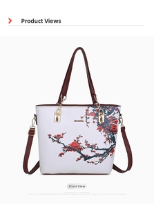 Front view of white tote bag featuring Chinese red plum blossom print and red handles
