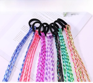 Detail of colorful braided hair extensions with black elastic bands for children