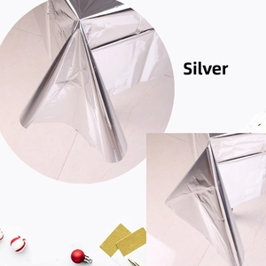 Detail of glossy silver foil tablecloth showing metallic texture and high reflectivity