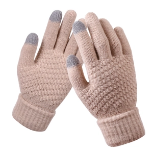Detail of three-finger touchscreen conductive yarn tips on beige knit winter gloves