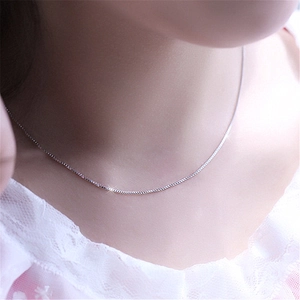 Elegant 1mm silver-plated stainless steel box chain necklace worn by a model