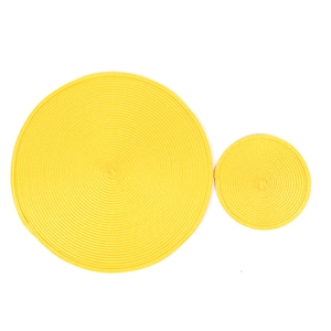 Detail of yellow round woven placemats with tight spiral texture and heat resistance